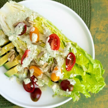 A Romaine salad with tomoatoes and avocado.
