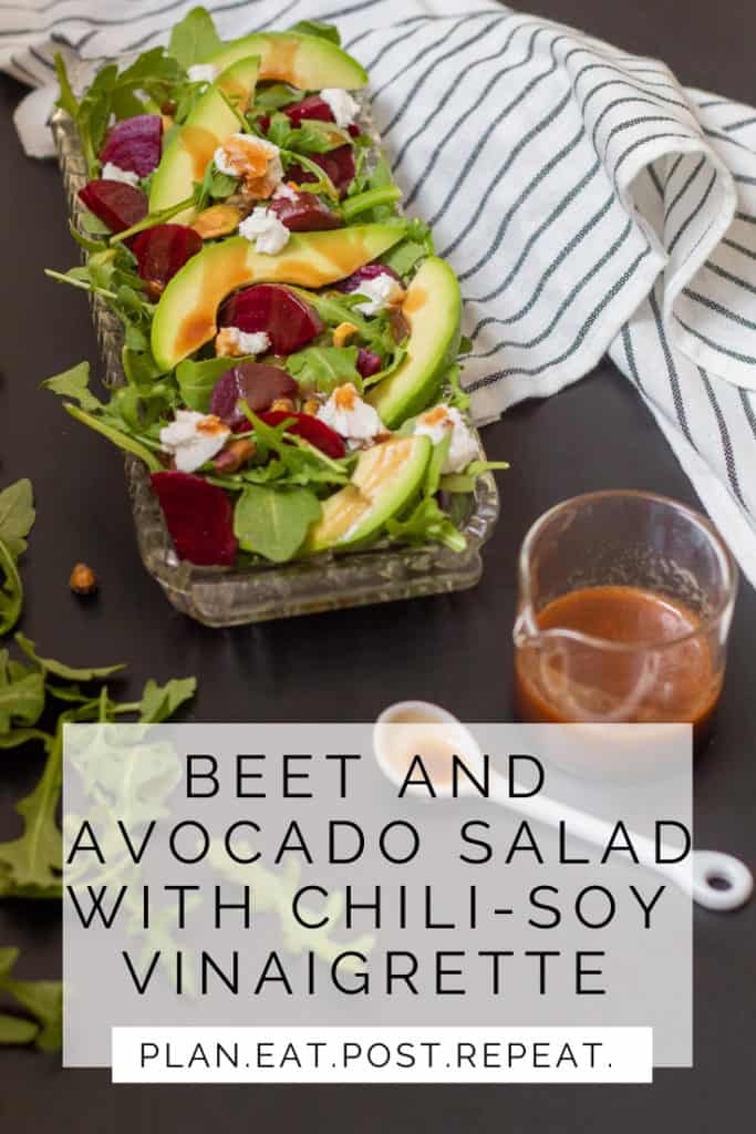A beet and avocado salad in a glass tray sits on a black surface. The words "beet and avocado salad with chili-soy vinaigrette" are aling the bottom above "Plan. Eat. Post. Repeat."