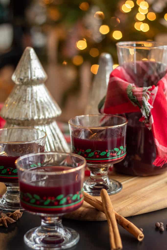 Mulled Wine is served from a wooden tray on a table with silver trees.