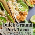 A gray plate with tacos in charred tortillas with pork, avocado, jalapeno, and slaw filling with the words, "Quick Ground Pork Tacos with Corn and Cabbage Slaw" and "Plan. Eat. Post. Repeat." superimposed over the bottom.