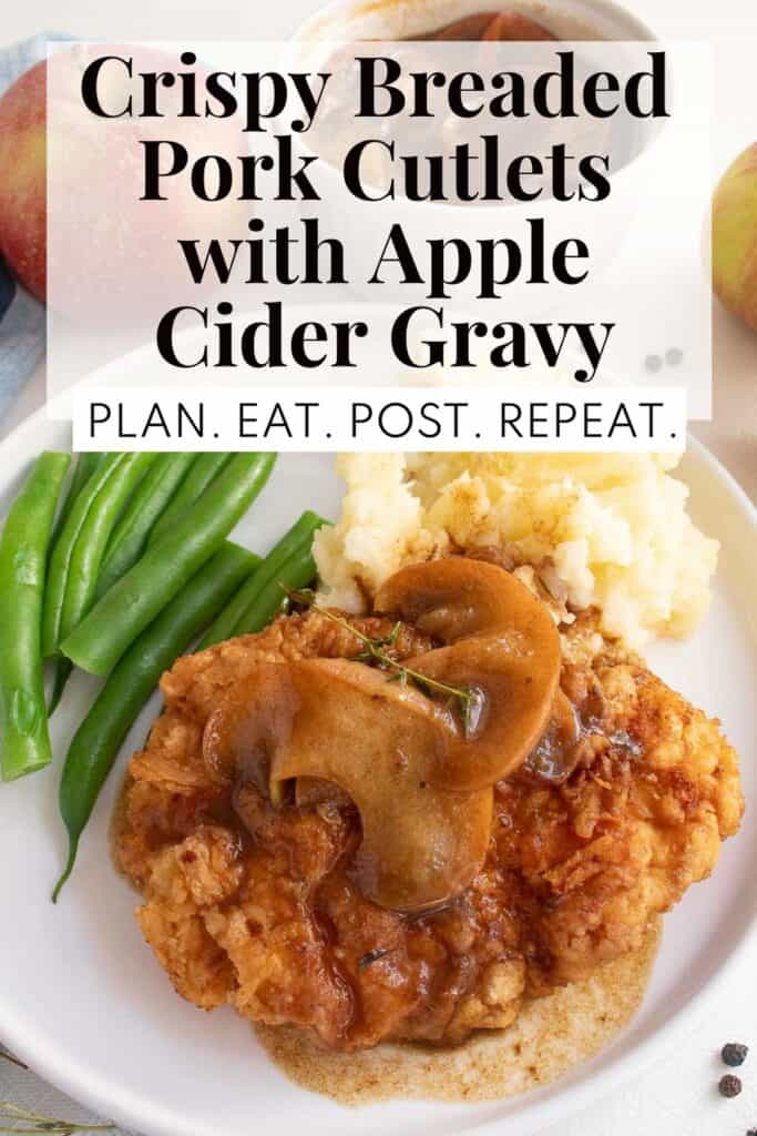 A serving of golden breaded pork and apples on a white plate with green beans and mashed potatoes with the words, "Crispy Breaded Pork Cutlets with Apple Cider Gravy" and "Plan. Eat. Post. Repeat." in a box at the top of the image.