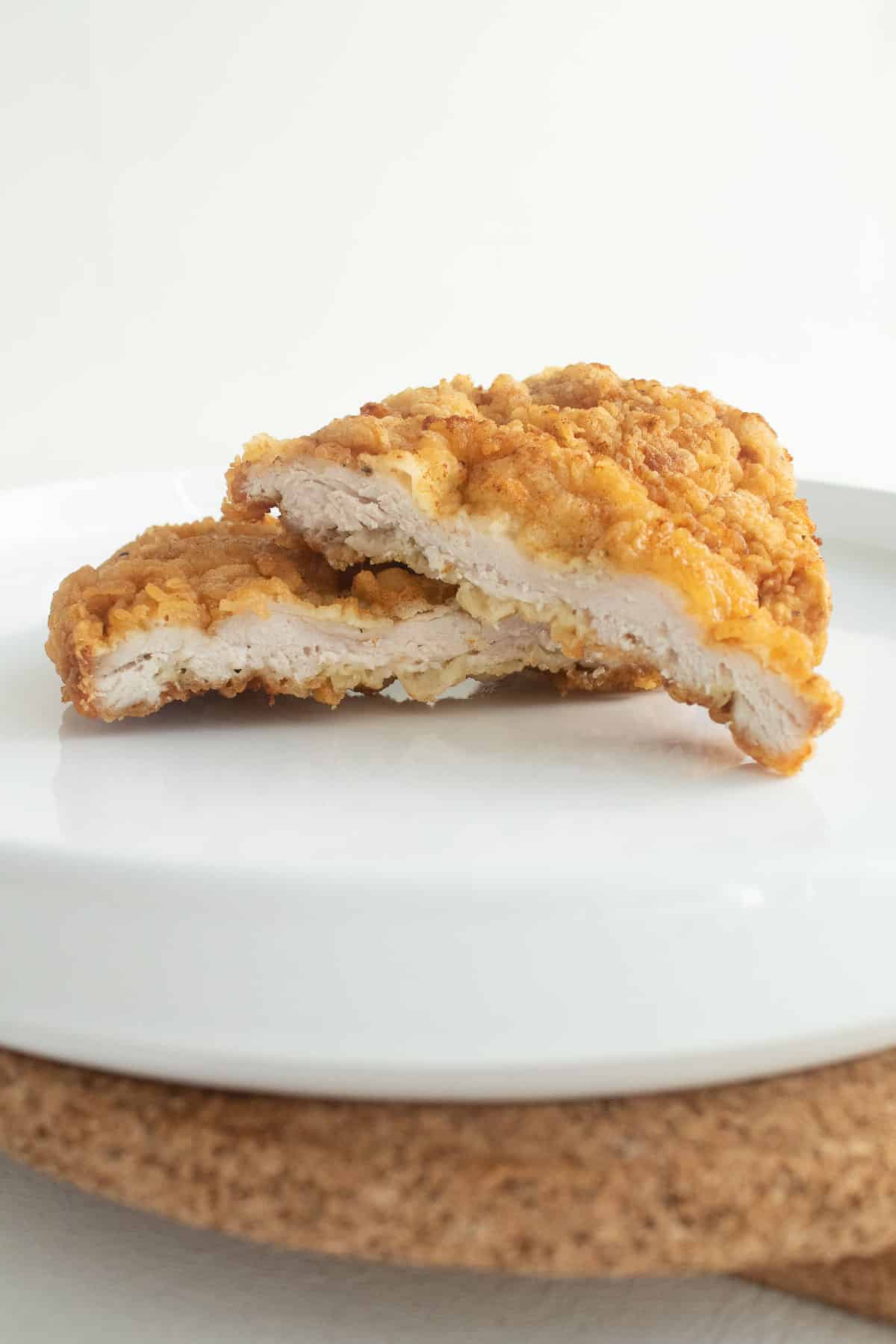 A breaded pork cutlet sliced in half to reveal the texture.