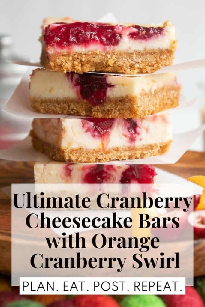 A stack of red and white dessert bars with brown graham cracker crust sitting on a wood plate. The words, "Ultimate Cranberry Cheesecake Bars with Orange Cranberry Swirl" and "Plan. Eat. Post. Repeat." are in a box at the bottom.