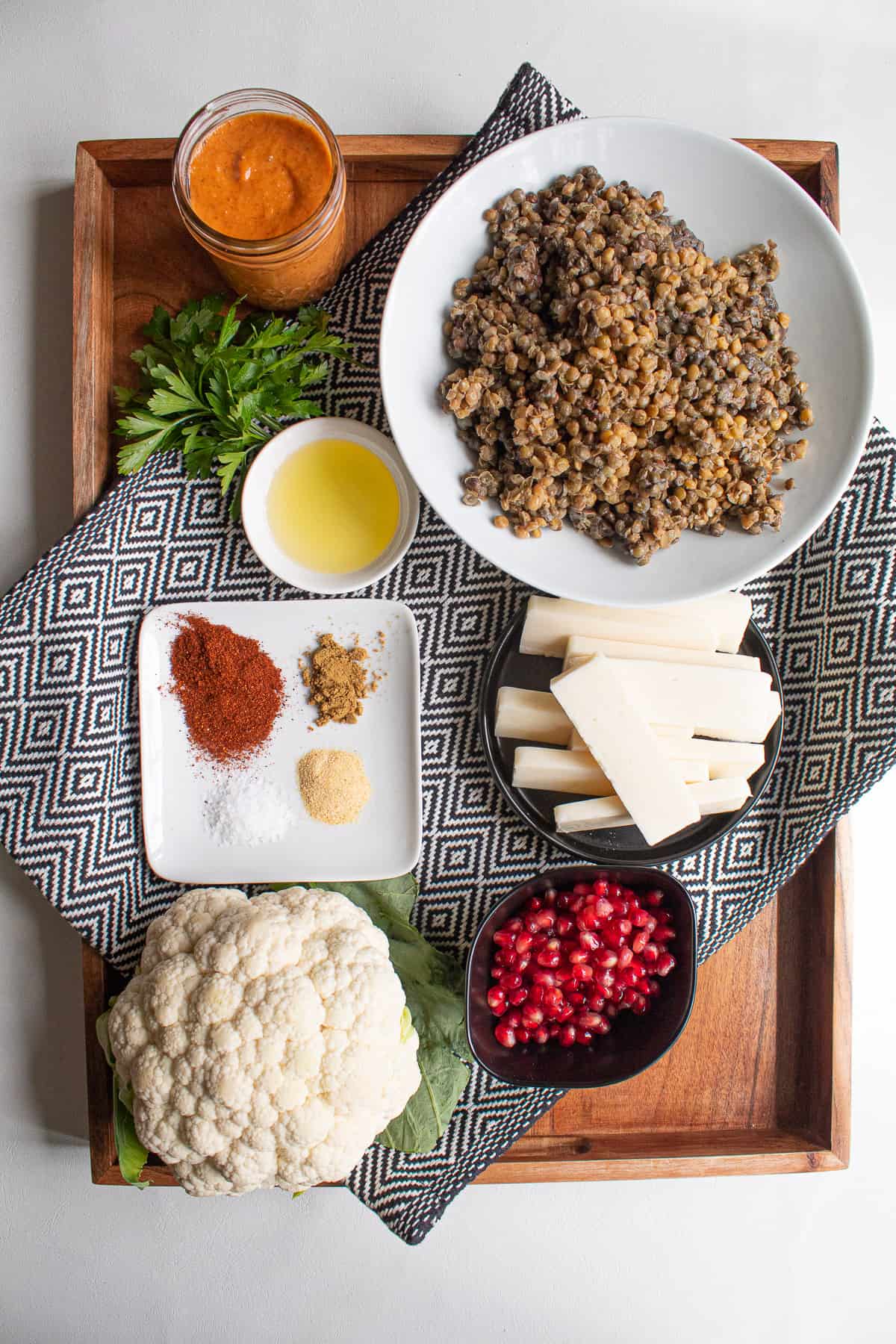 Ingredients for the lentil salad are displayed in a wooden tray