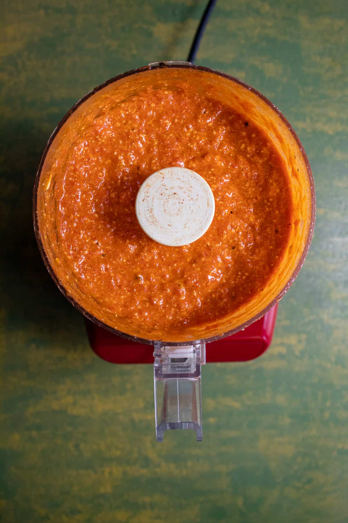 The bright orange sauce after being blended in the mini processor.