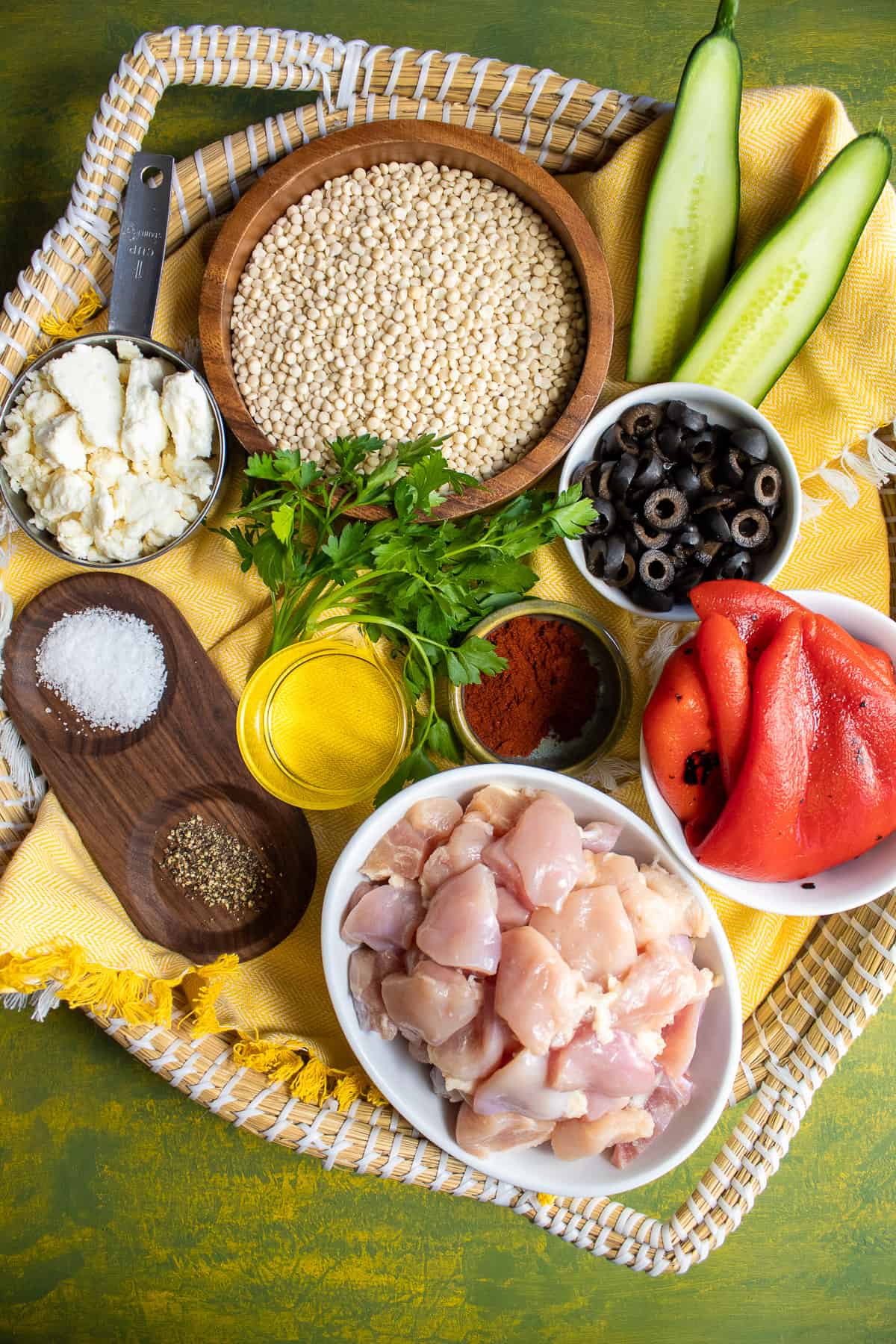 Ingredients for the recipe arranged in a basket on a green surface.