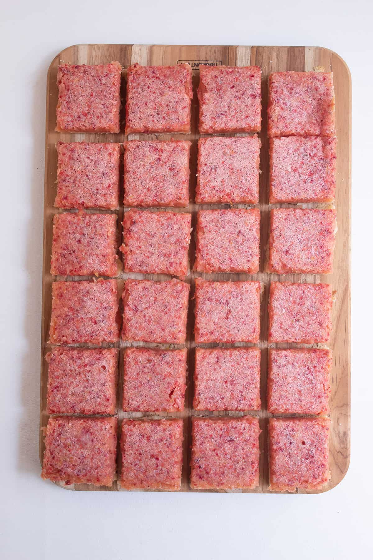 The trimmed pan of bars is cut into 24 squares for serving.