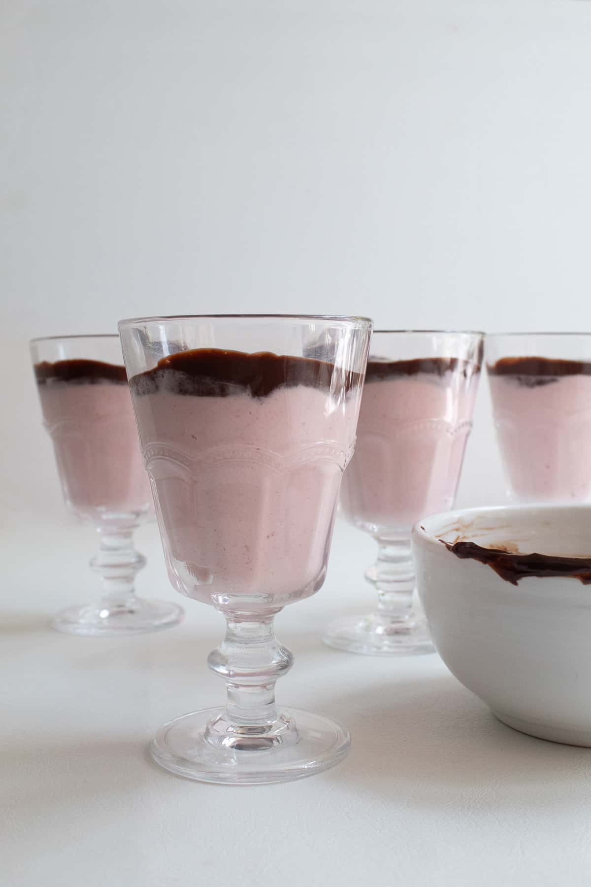 A layer of dark chocolate is added over the top of the mousse.