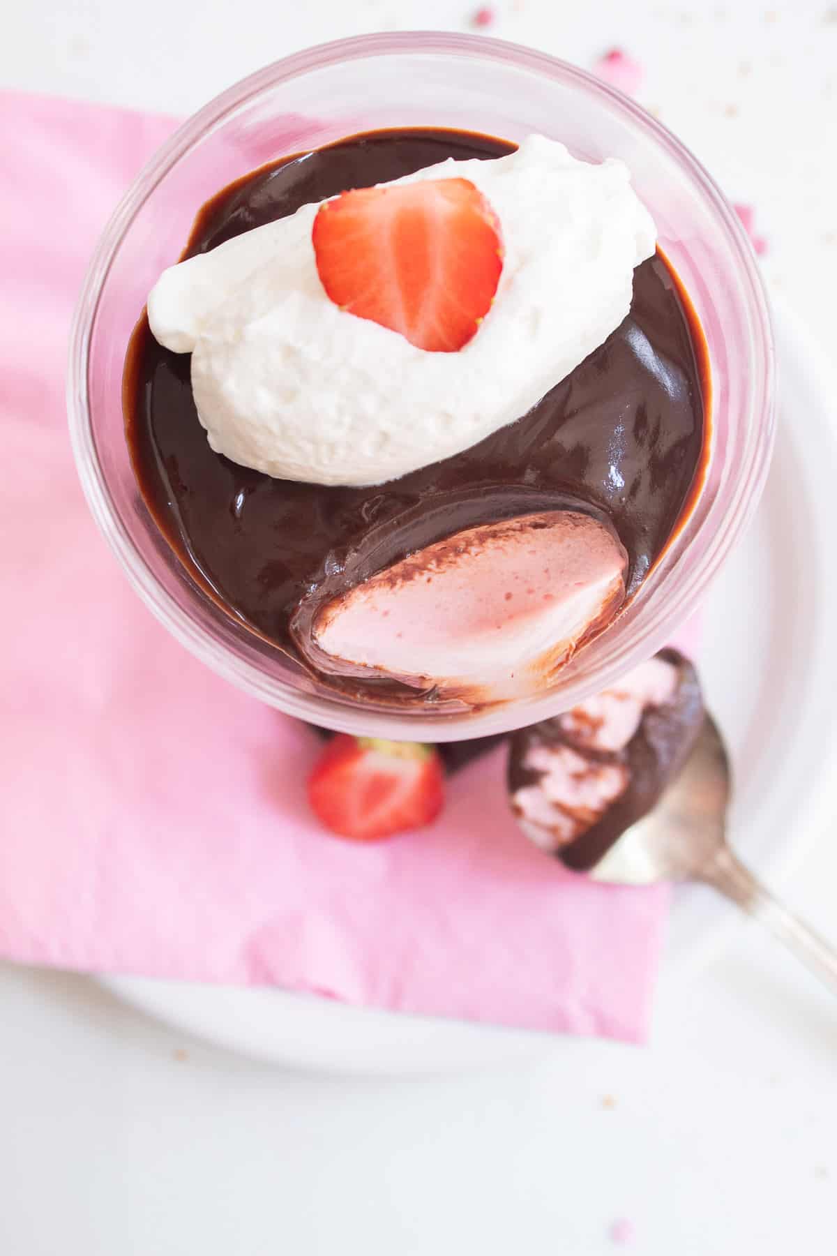 An overhead image of the strawberry mousse with a spoonful taken away.