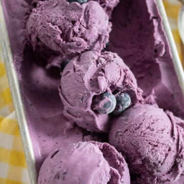 The frozen ice cream scooped in heaps in a loaf pan.