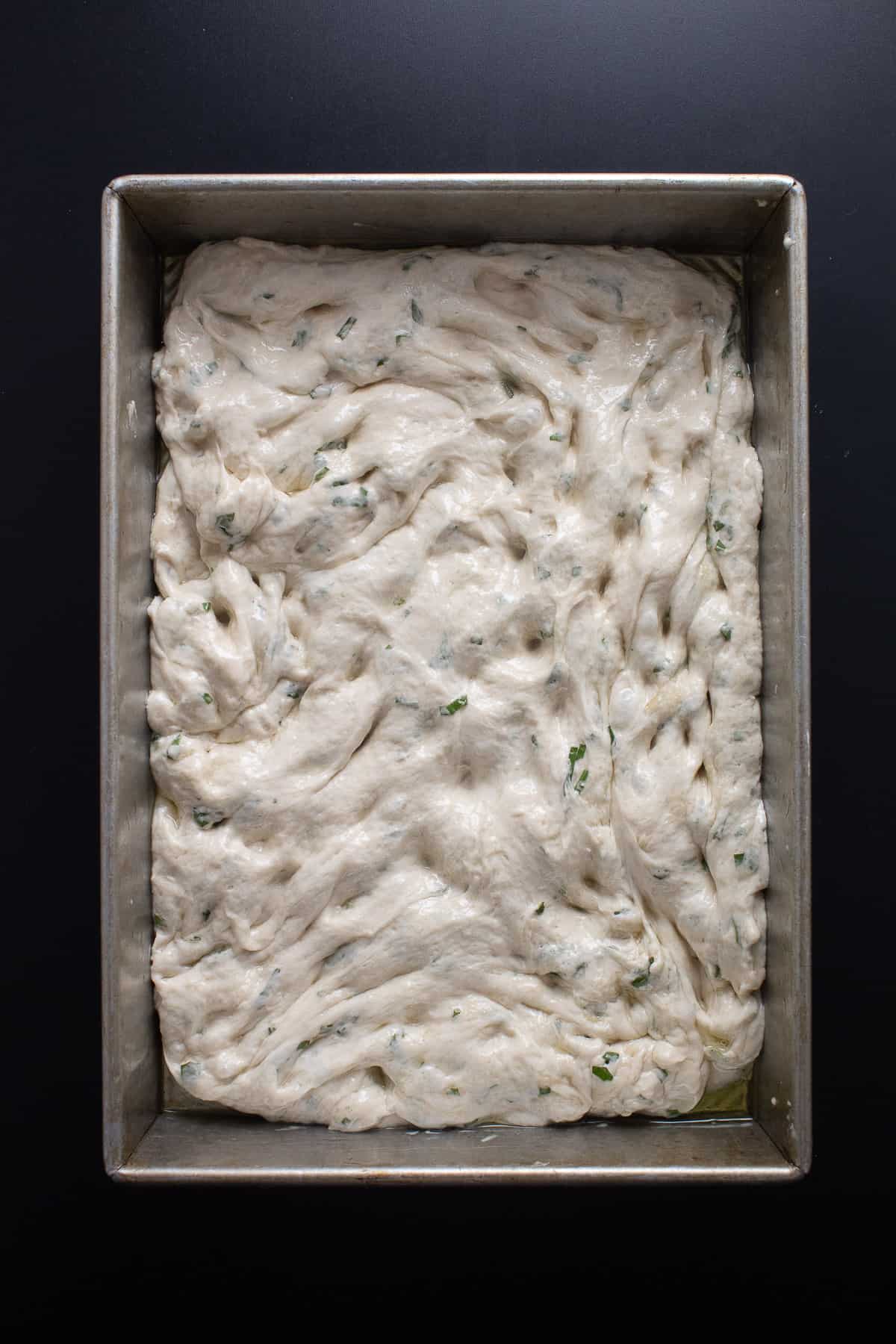 The oiled dough stretched out to cover the bottom of the baking dish.