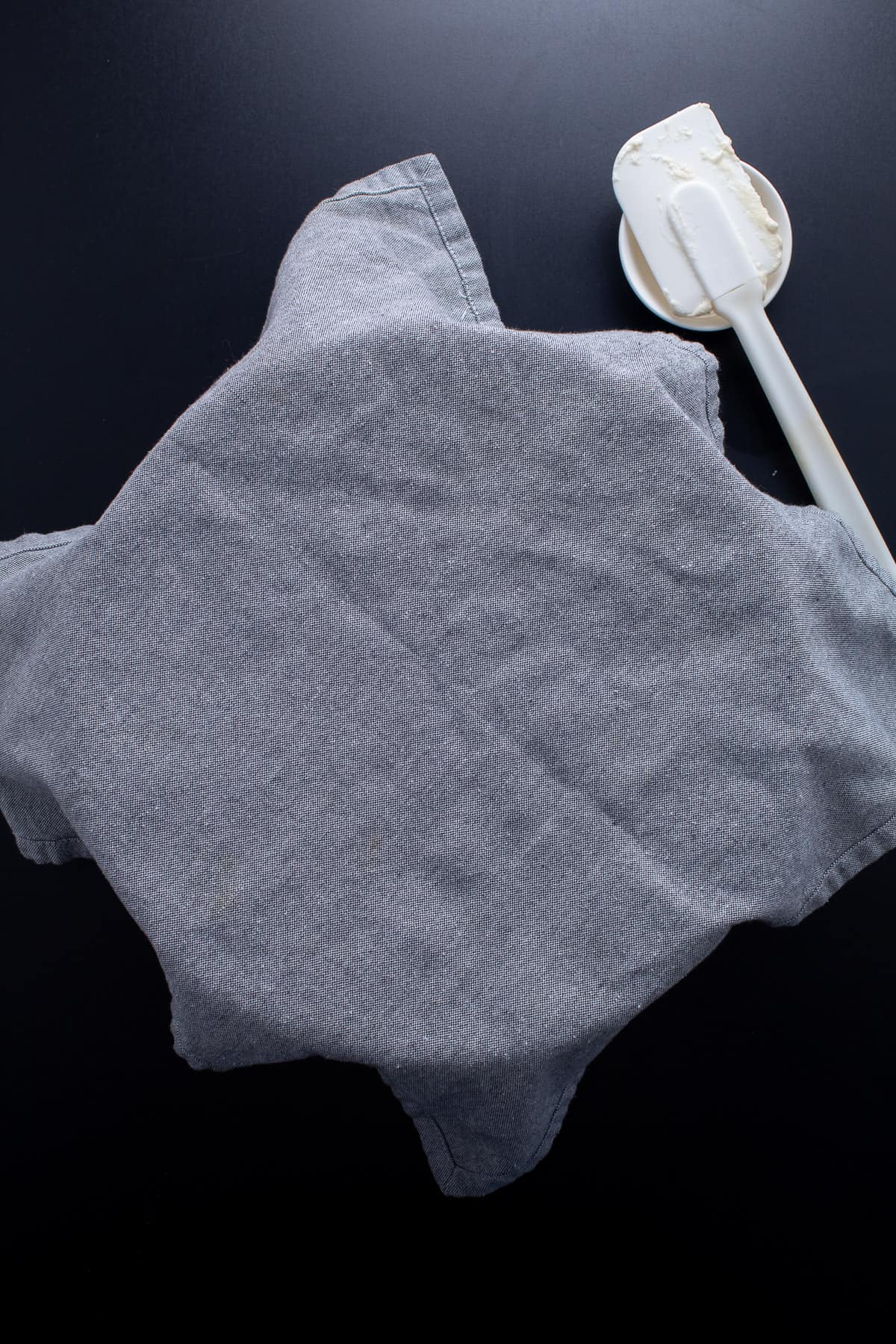 The dough covered with a kitchen towel while it rests.