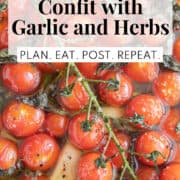 Burst cherry tomatoes sit in oil with pepper, garlic cloves, herbs, and salt. A white box at the top of the image contains the words, "cherry tomato confit with garlic and herbs" and "Plan. Eat. Post. Repeat."