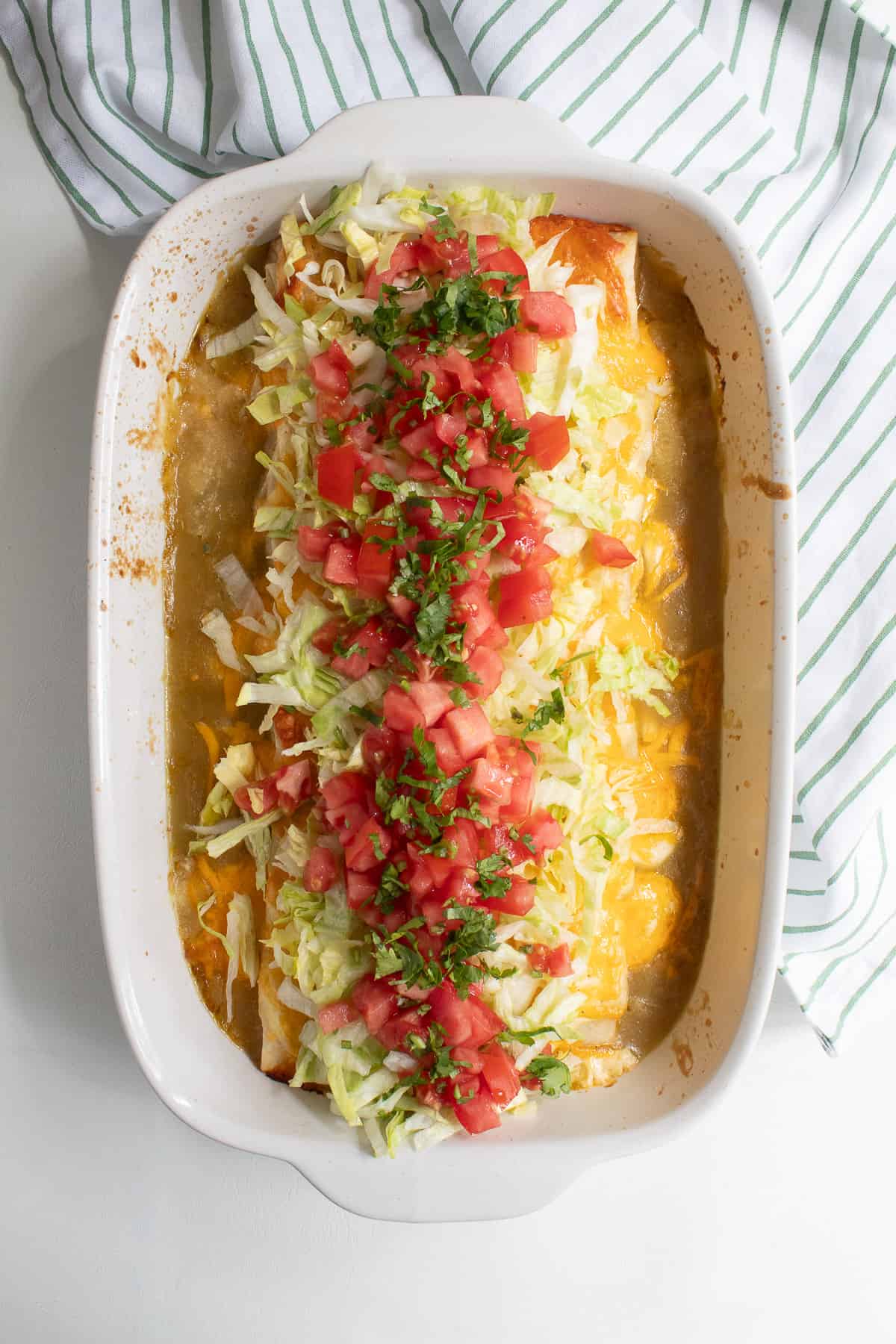 The finished casserole with shredded lettuce, tomatoes, and cilantro added on top.