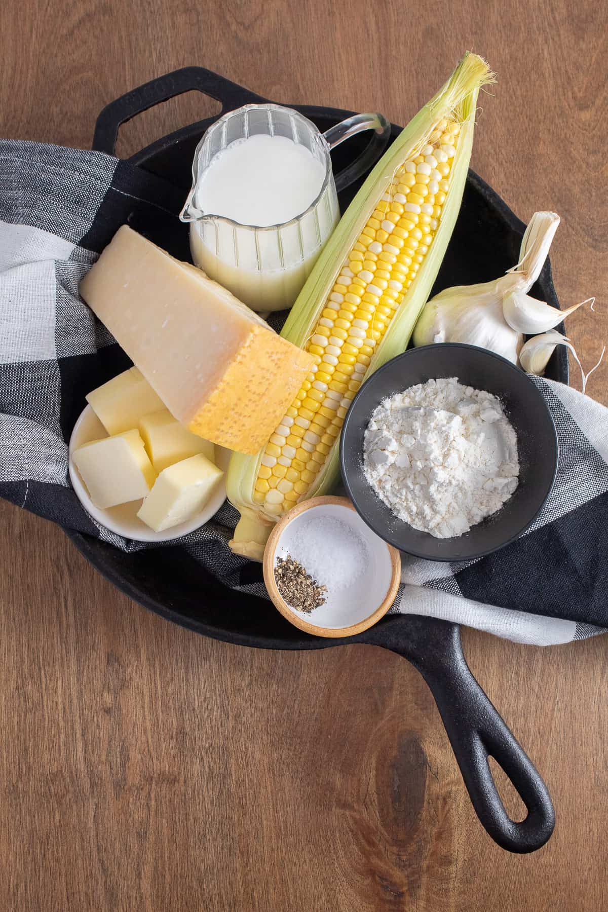 The ingredients for the gratin are piled into a black cast iron skillet.