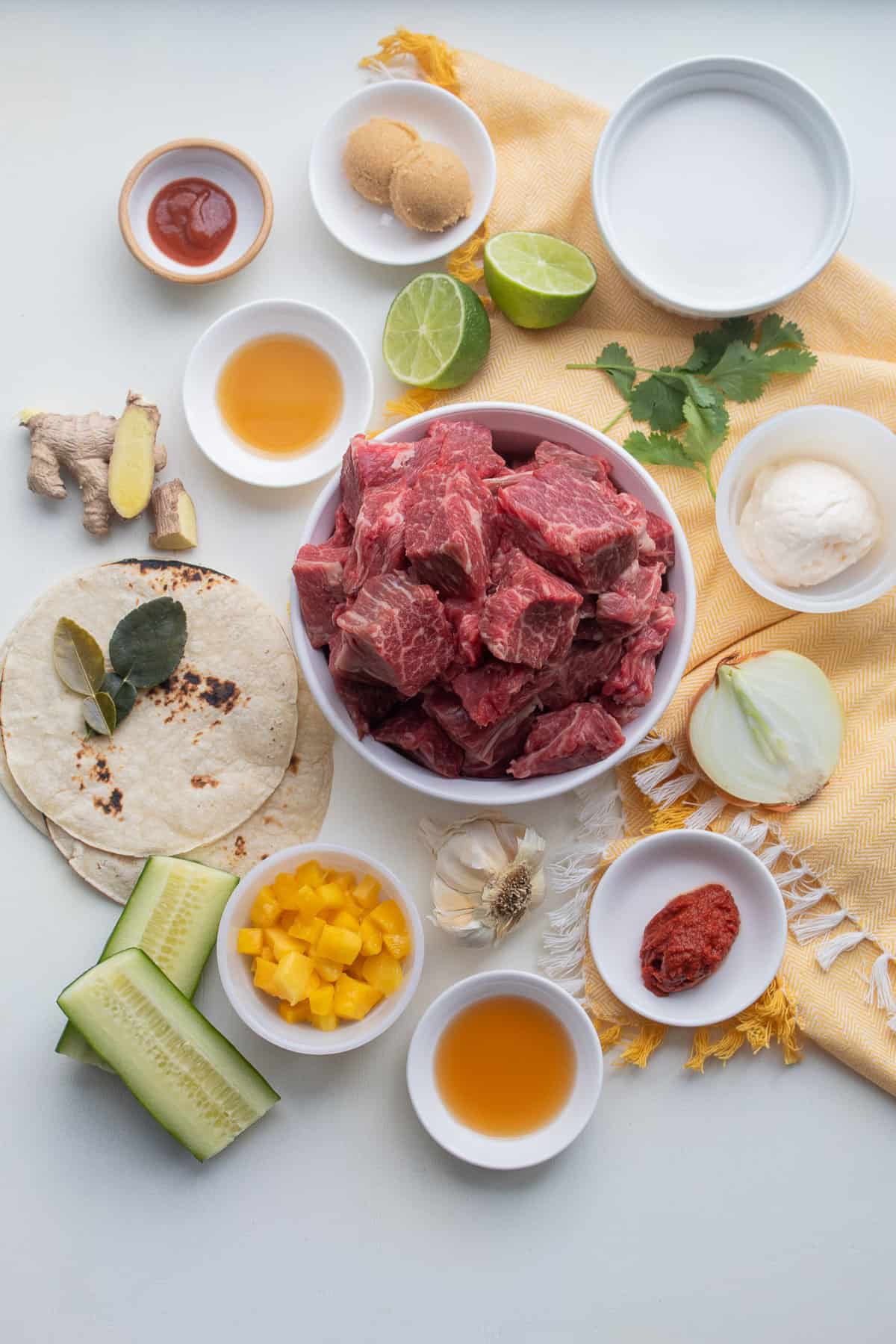 The ingredients for the dish are displayed on a white surface.