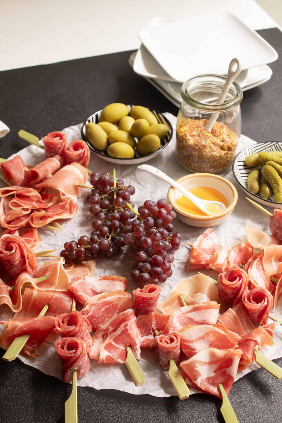 Detailed up-close image of the various textures of the charcuterie skewers: ruffled, rosettes, and folds.