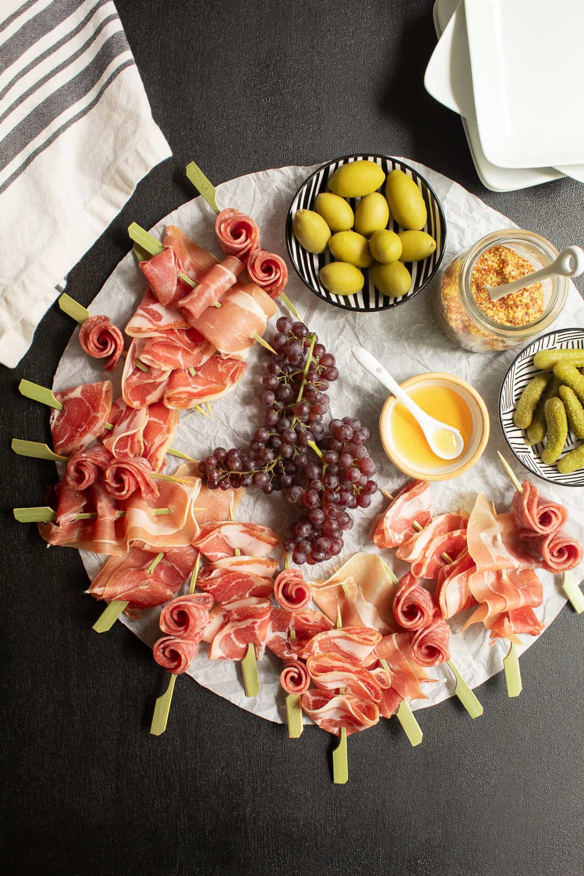 Charcuterie skewers arranged in a wreath for serving.