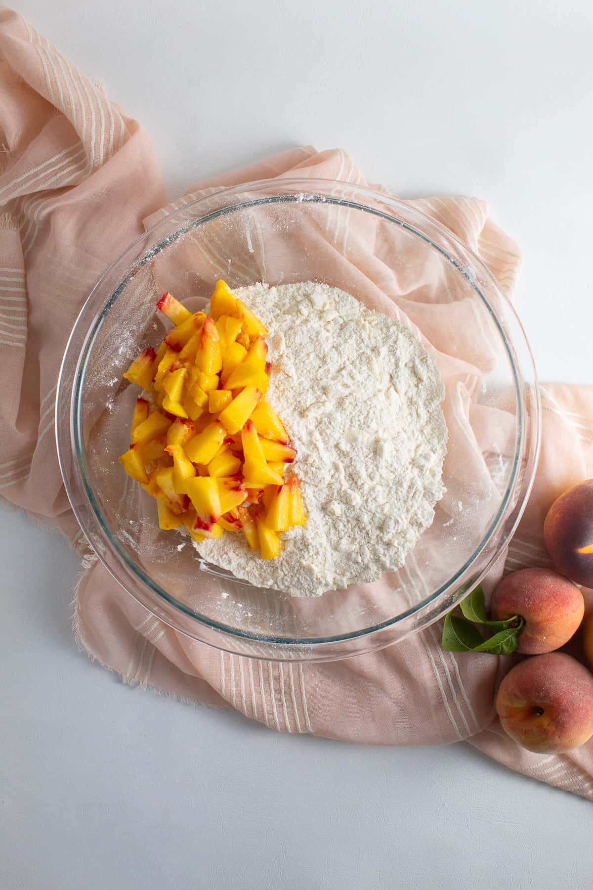 Fresh diced peaches are tossed with the butter and flour mixture.