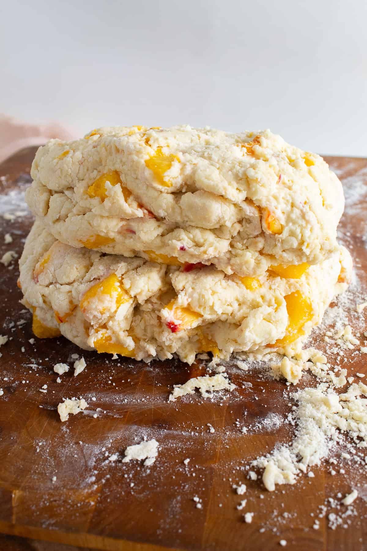 The dough is folded over itself to create two layers on the work surface.