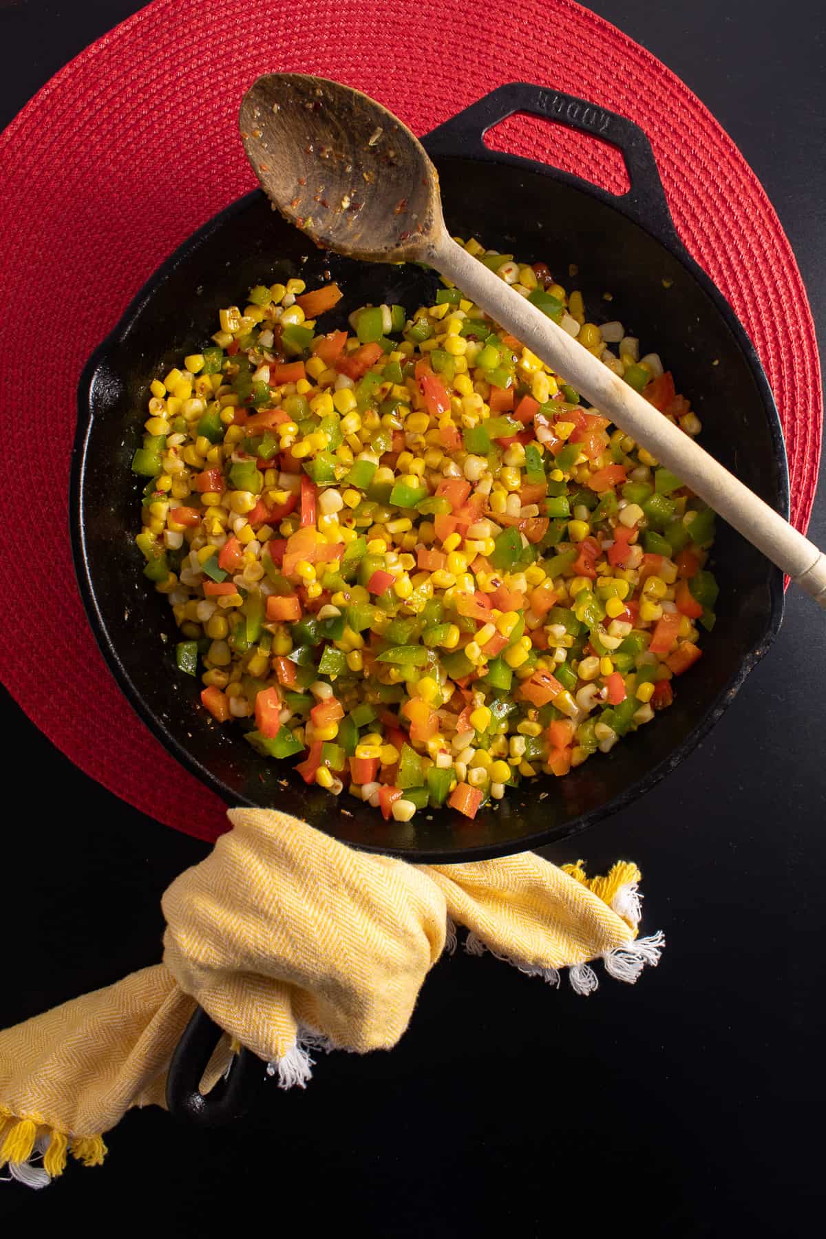 Chili onion crunch is stirred into the cooked corn and peppers.