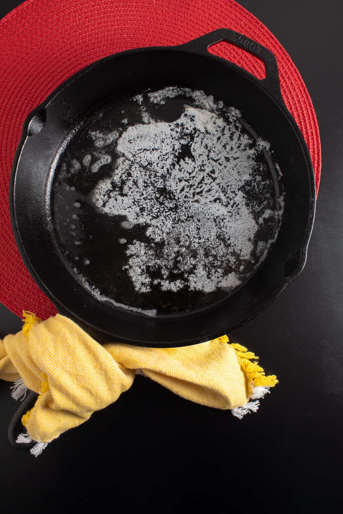 Butter is melted in the bottom of a cast iron skillet.