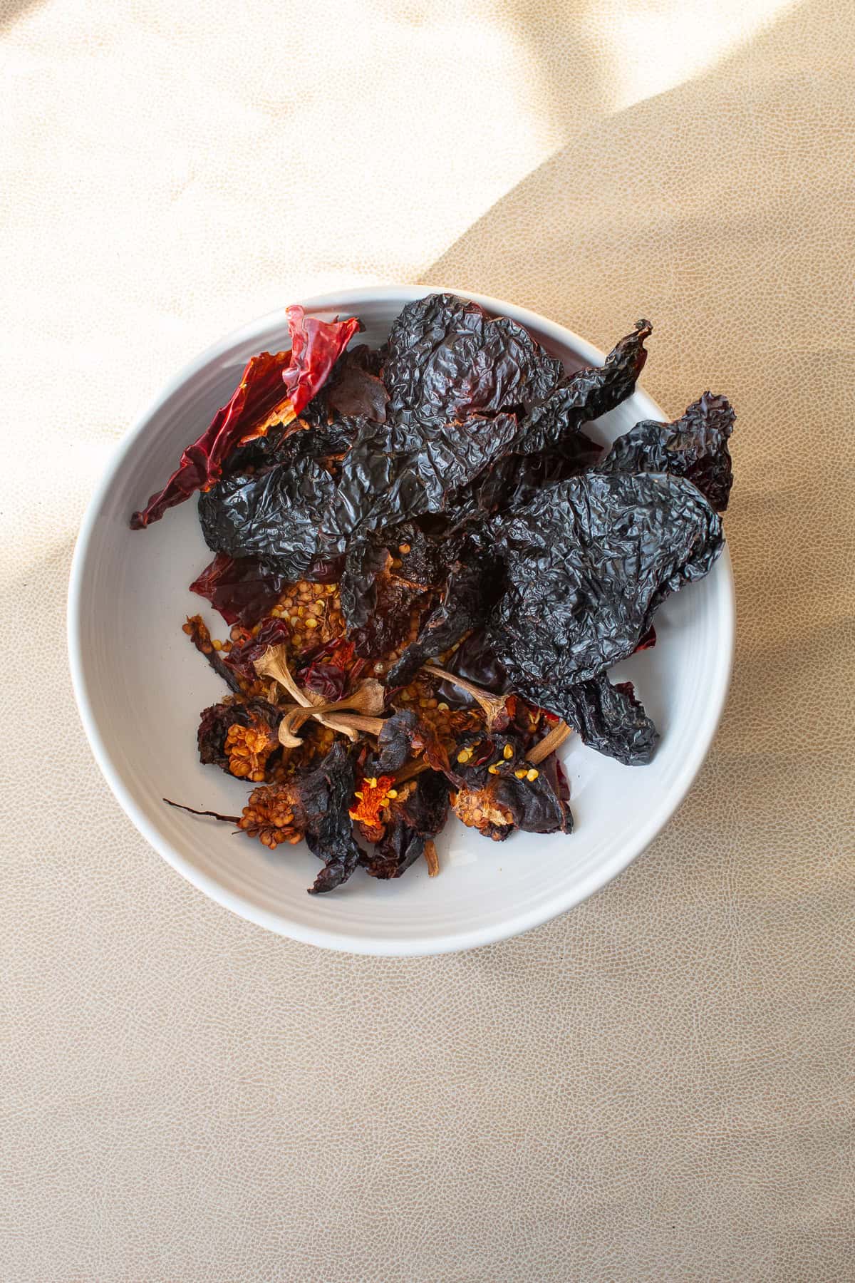 The toasted chiles are torn open and the seeds and stems are removed.