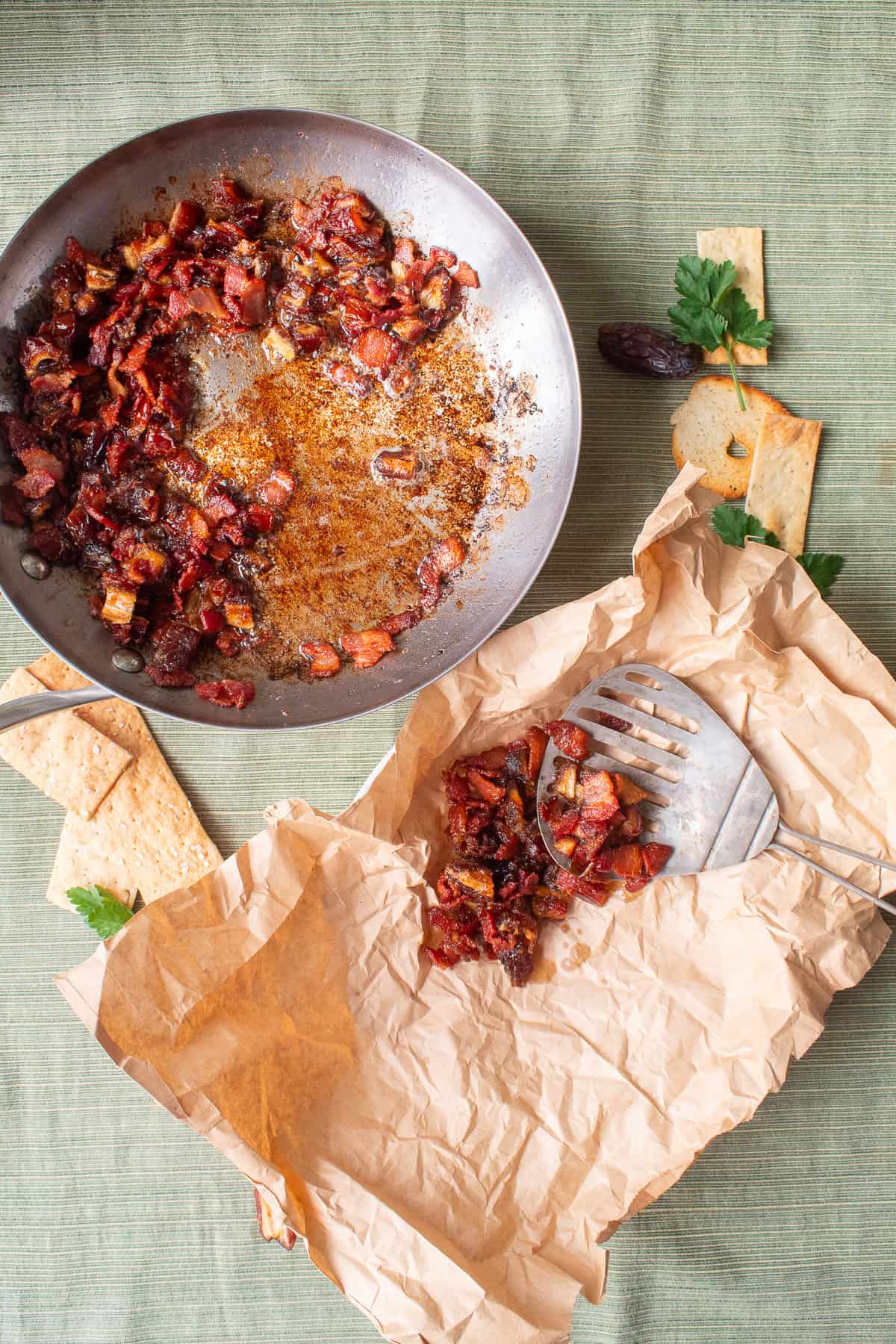 The bacon and dates are strained and excess grease is absorbed by brown paper.