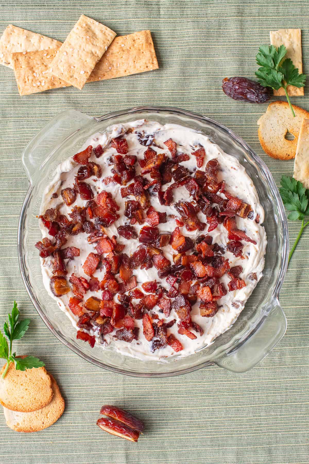 The cheese mixture is sprinkled with the remaining dates and bacon.