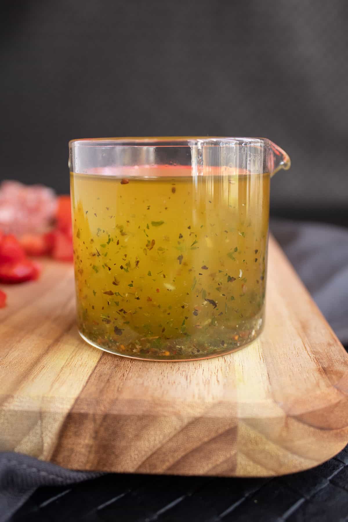 The oil from the marinated mozzarella is flecked with herbs and spices.