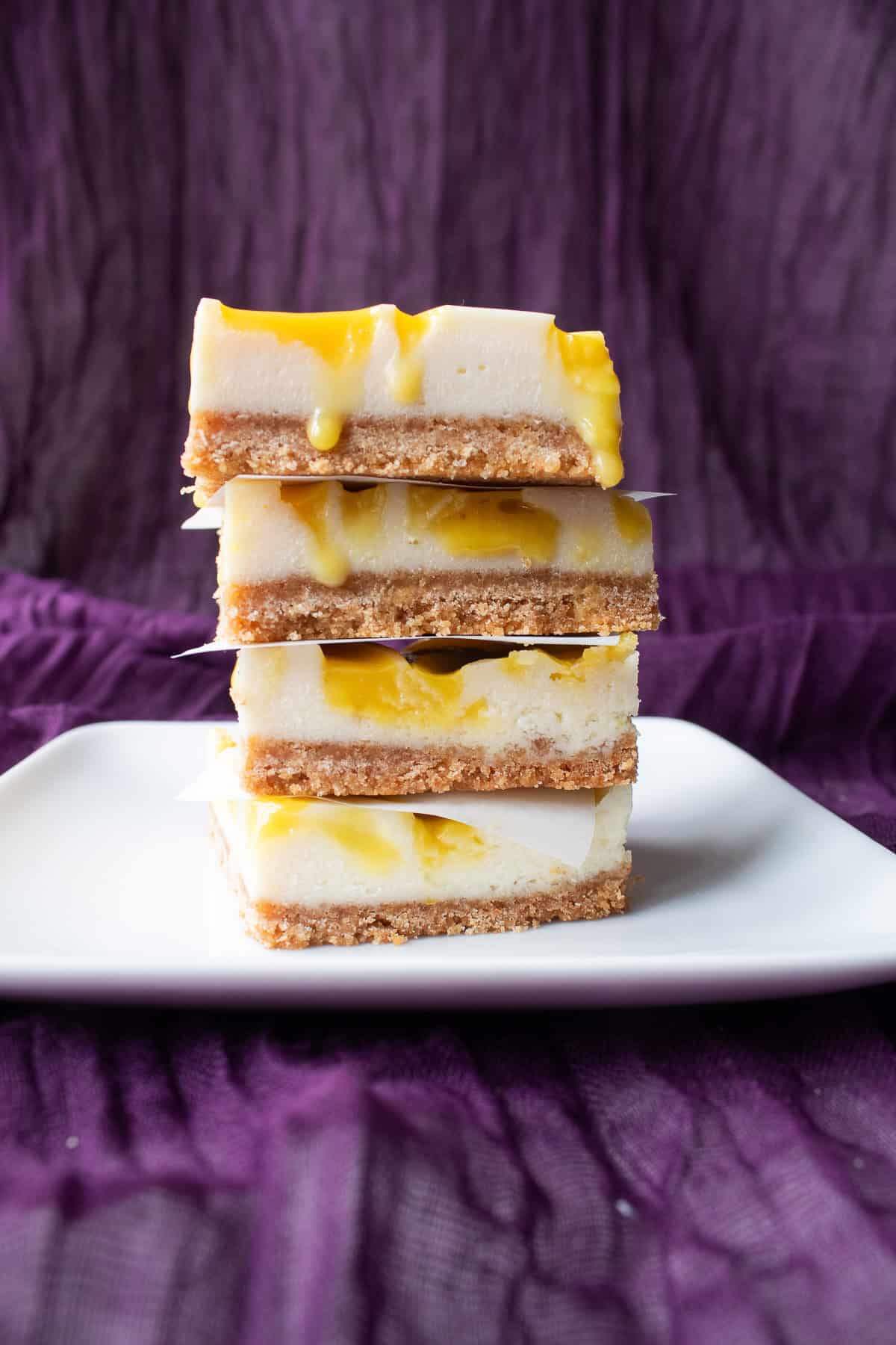 The bars are stacked four high and the lemon curd drips down the edges.