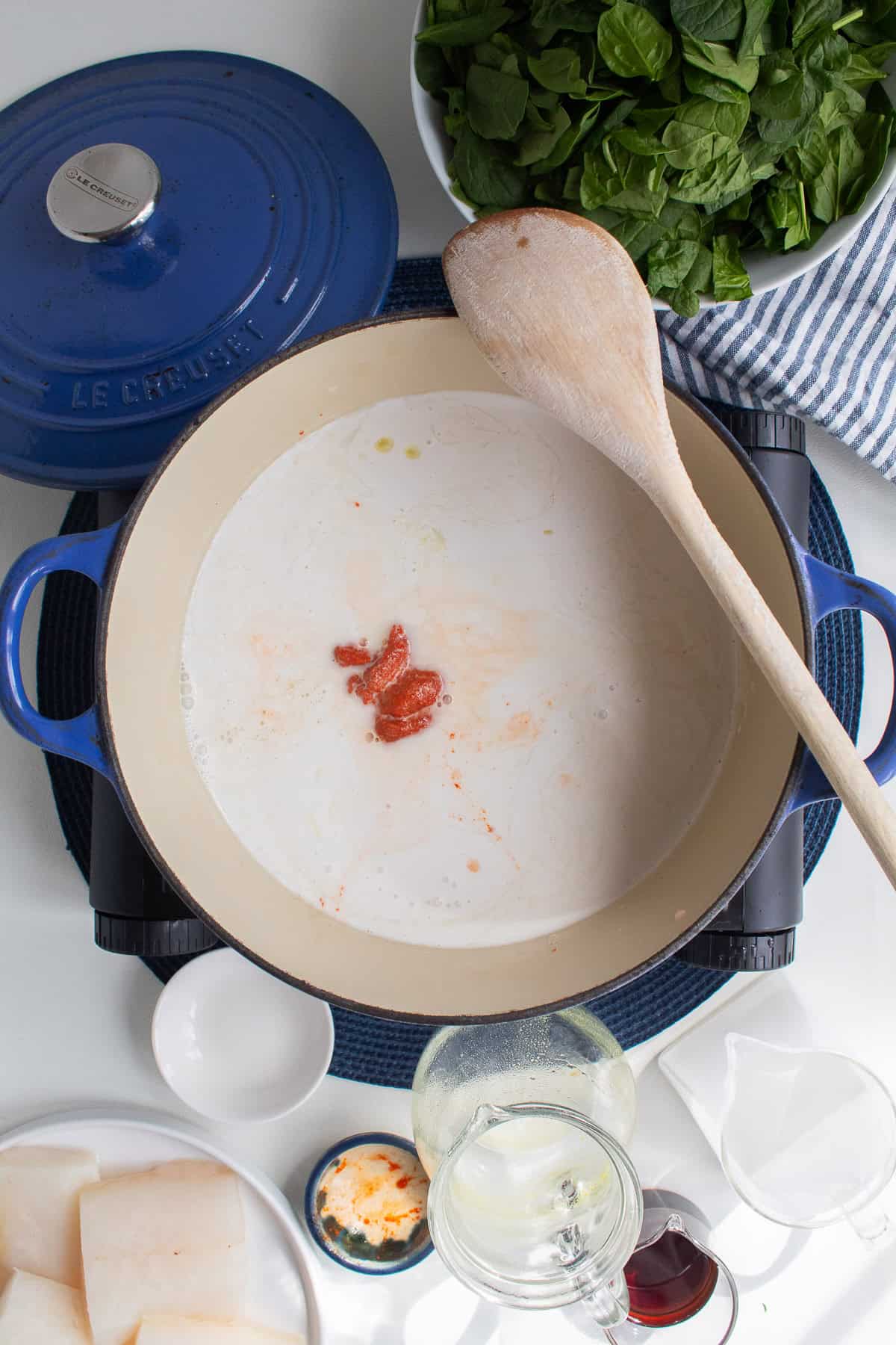 Coconut milk, chicken stock, brown sugar, and curry paste are heated together in the Dutch oven.