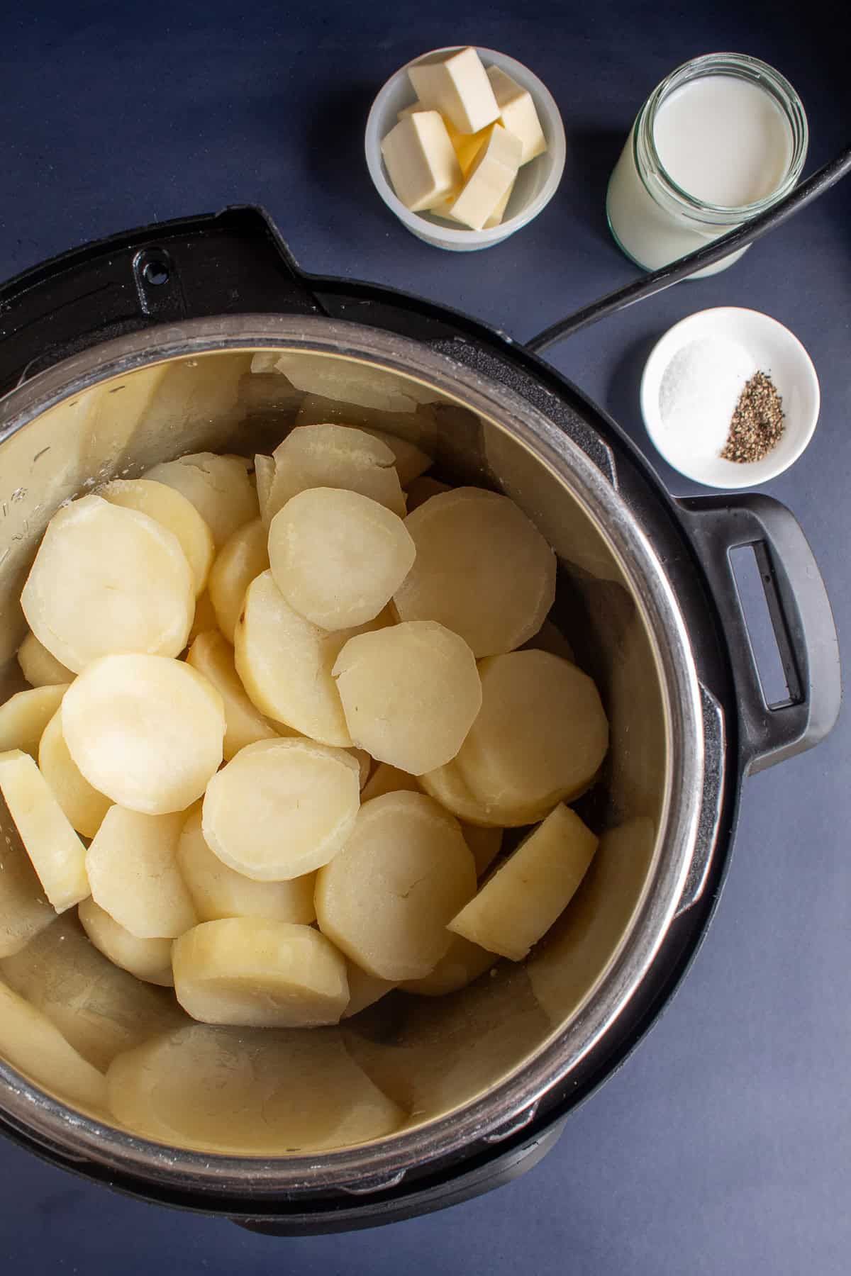 The cooked potatoes sit in the bottom of the pressure cooker insert.