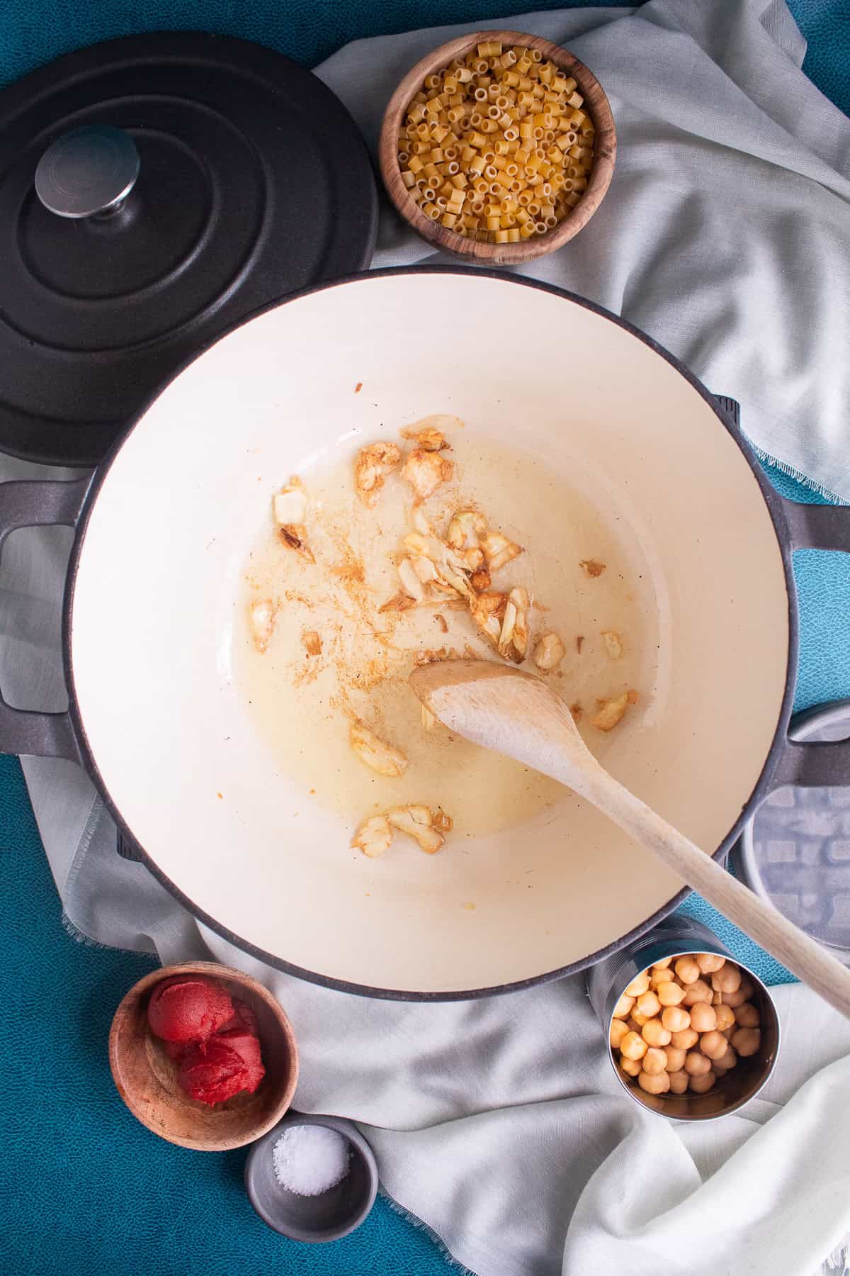 The garlic is cooked in the oil until it is golden.