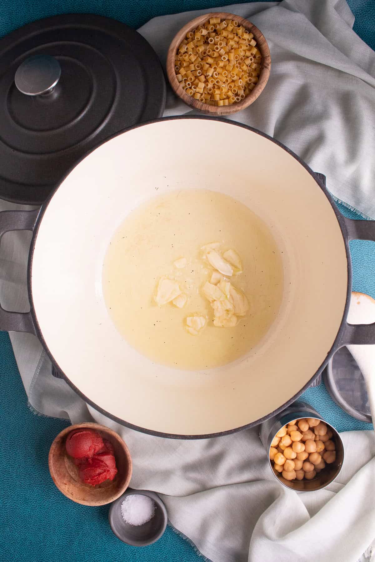 Garlic is added to the oil in the large pot.