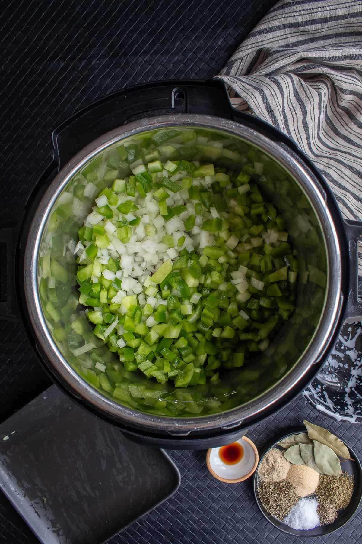 The diced peppers, onions, and celery are added to the pot on top of the beans.