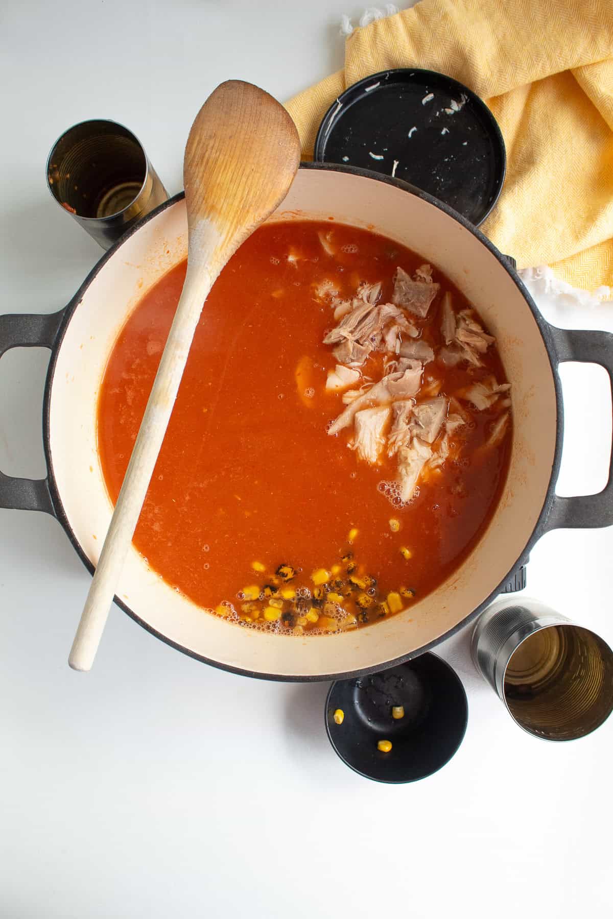The pureed chile and tomato are added to the stock, chicken, beans, and corn in the soup pot.