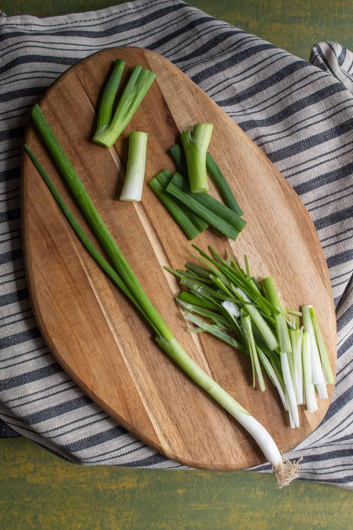 Scallions are cut into 2-inch sections and then sliced thinly.