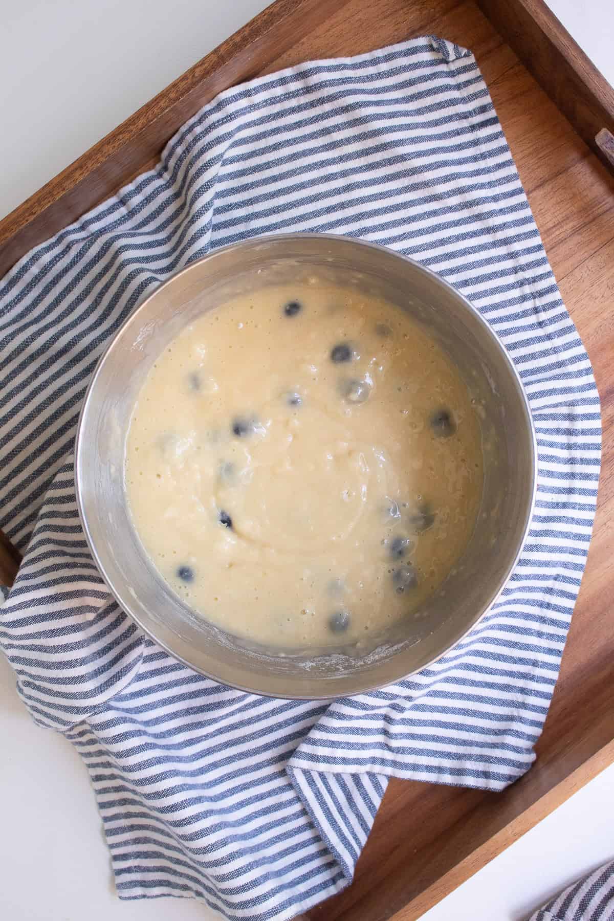 The cake batter is mixed together in a large silver bowl.