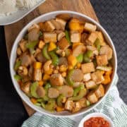 A platter of the stir fry sits on a wooden board.