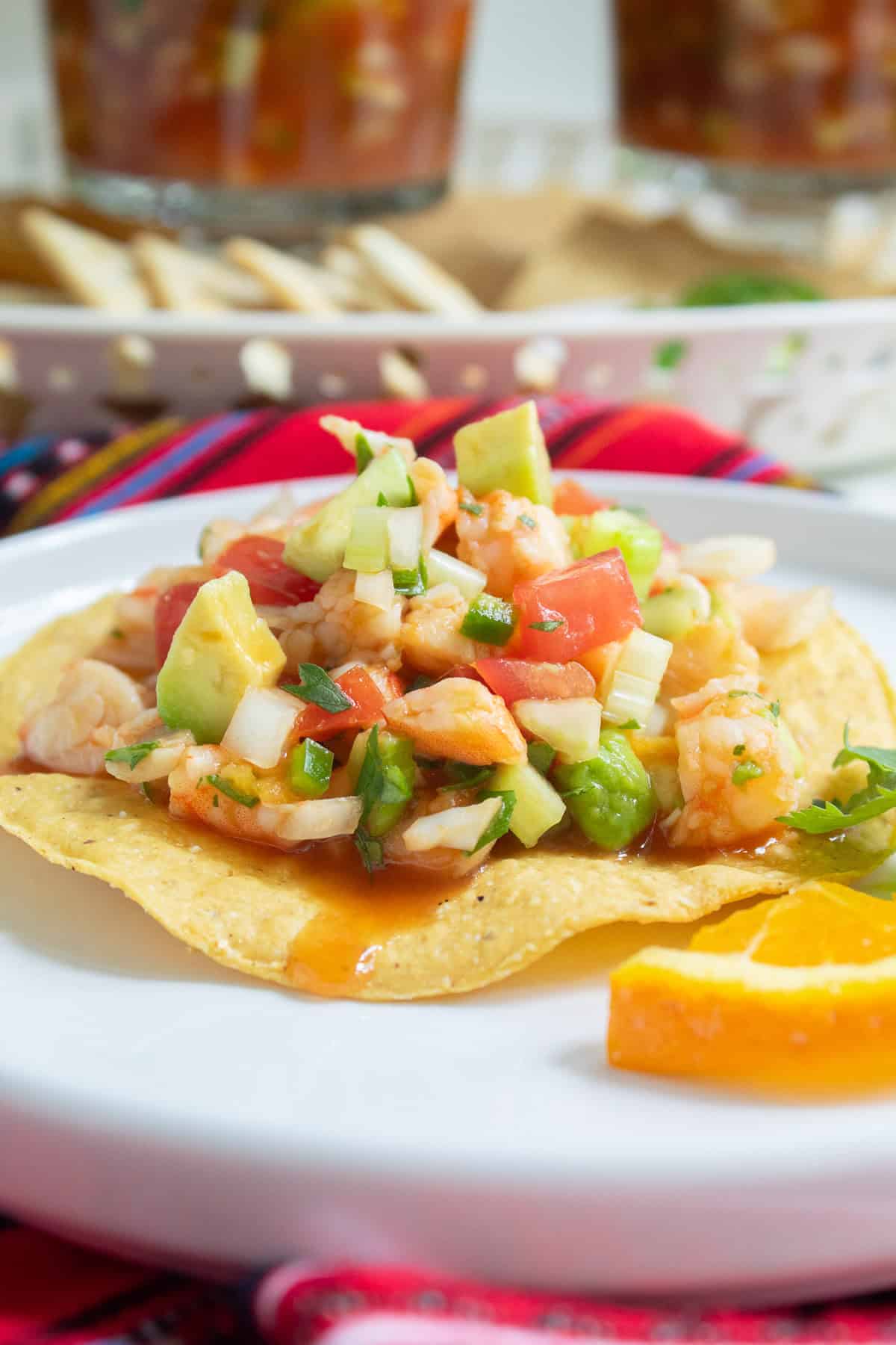 The shrimp cocktail is spooned over a crisp tostada.