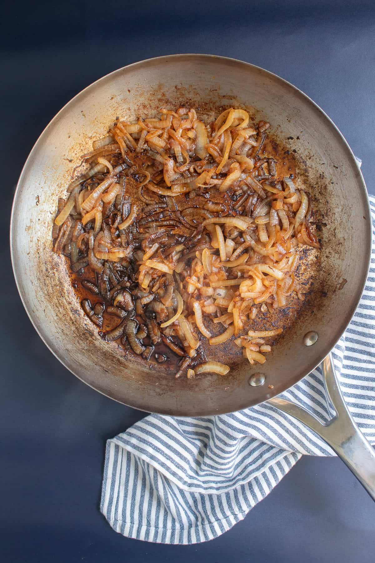 Dark balsamic vinegar and soy sauce are added to the skillet with caramelized onions after 30 minutes.