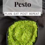 A black bowl of the vibrant green pesto. A white text box at the top of the image contains the words, "pea pesto" and "plan. eat. post. repeat."
