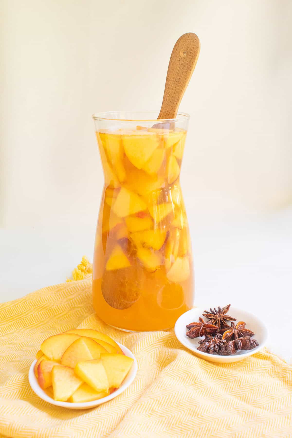 The pitcher of sangria stirred with a wooden paddle.