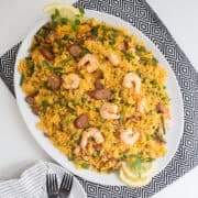 The finished saffron rice is transferred to a large oval platter.