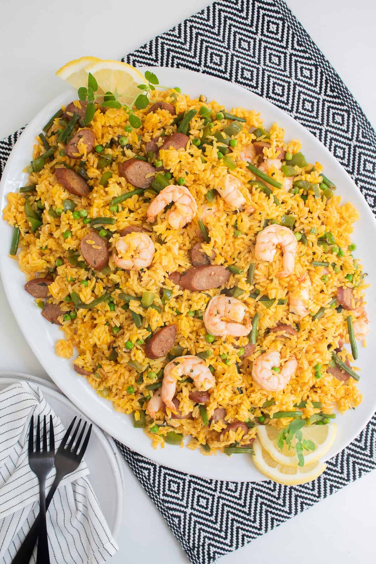 The finished saffron rice is transferred to a large oval platter.