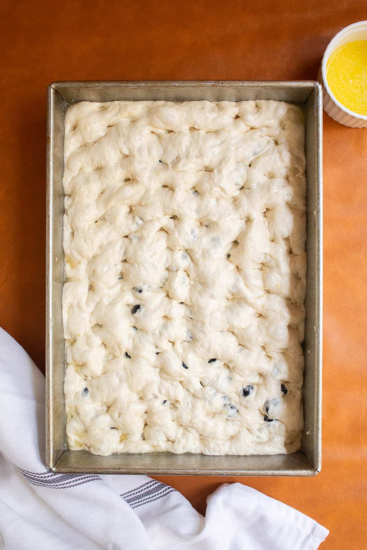The entire surface of the dough is dimpled.