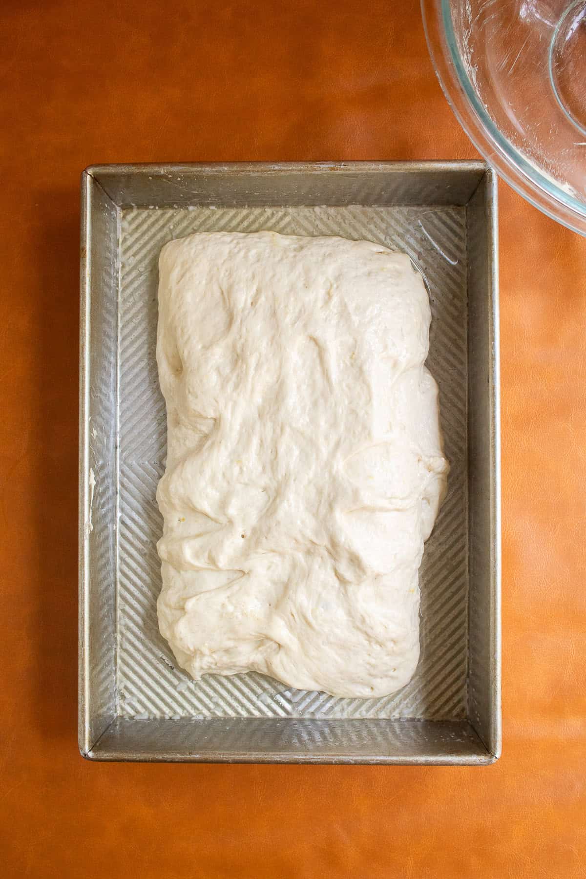 The bundle of dough is rotated 90 degrees an flipped upside down.