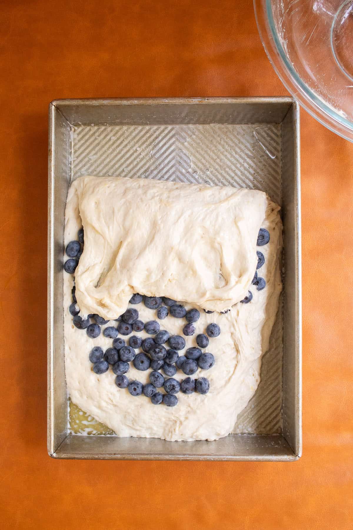 The top third of the dough is folded over the berries,