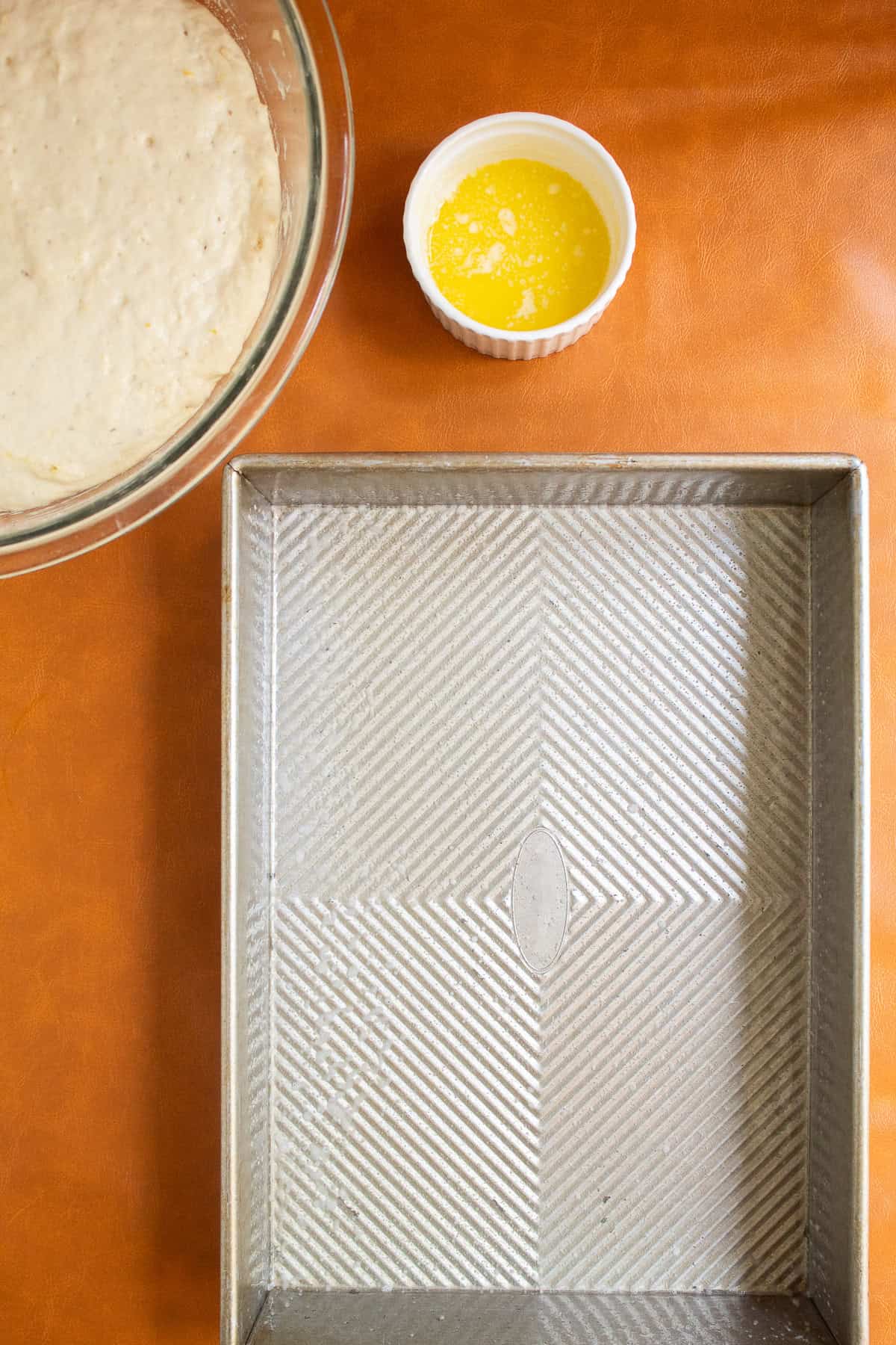 A pan is evenly coated with a mixture of oil and butter.